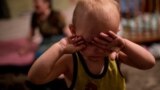 Ukraine -- A child is crying in the bomb shelter in Petrovskiy district of Donetsk 6/8/15