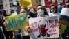 MEXICO – People holding banners attend an anti-war protest outside the Russian Embassy, after Russia launched a massive military operation against Ukraine, in Mexico City, Mexico February 26, 2022