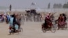 PAKISTAN -- Supporters of the Taliban carry the Taliban's signature white flags in the Afghan-Pakistan border town of Chaman, Pakistan, Wednesday, July 14, 2021.